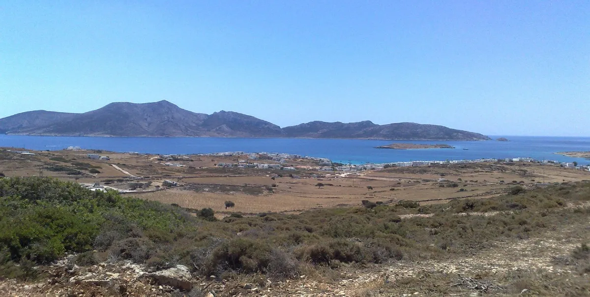 View across dry green hills and blue sea toward the island of Keros from Ano Koufonisi on a boat day trip from Naxos, Greece