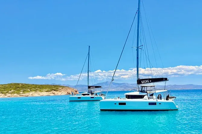 Sailing catamaran under way on turquoise Aegean water on an all-inclusive catamaran day cruise from Naxos