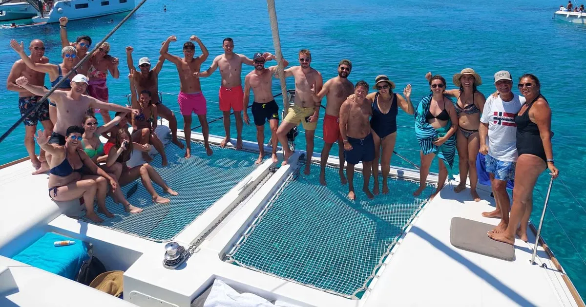 White Lagoon catamaran sailing past Cycladic coastline on a Naxos catamaran cruise with lunch